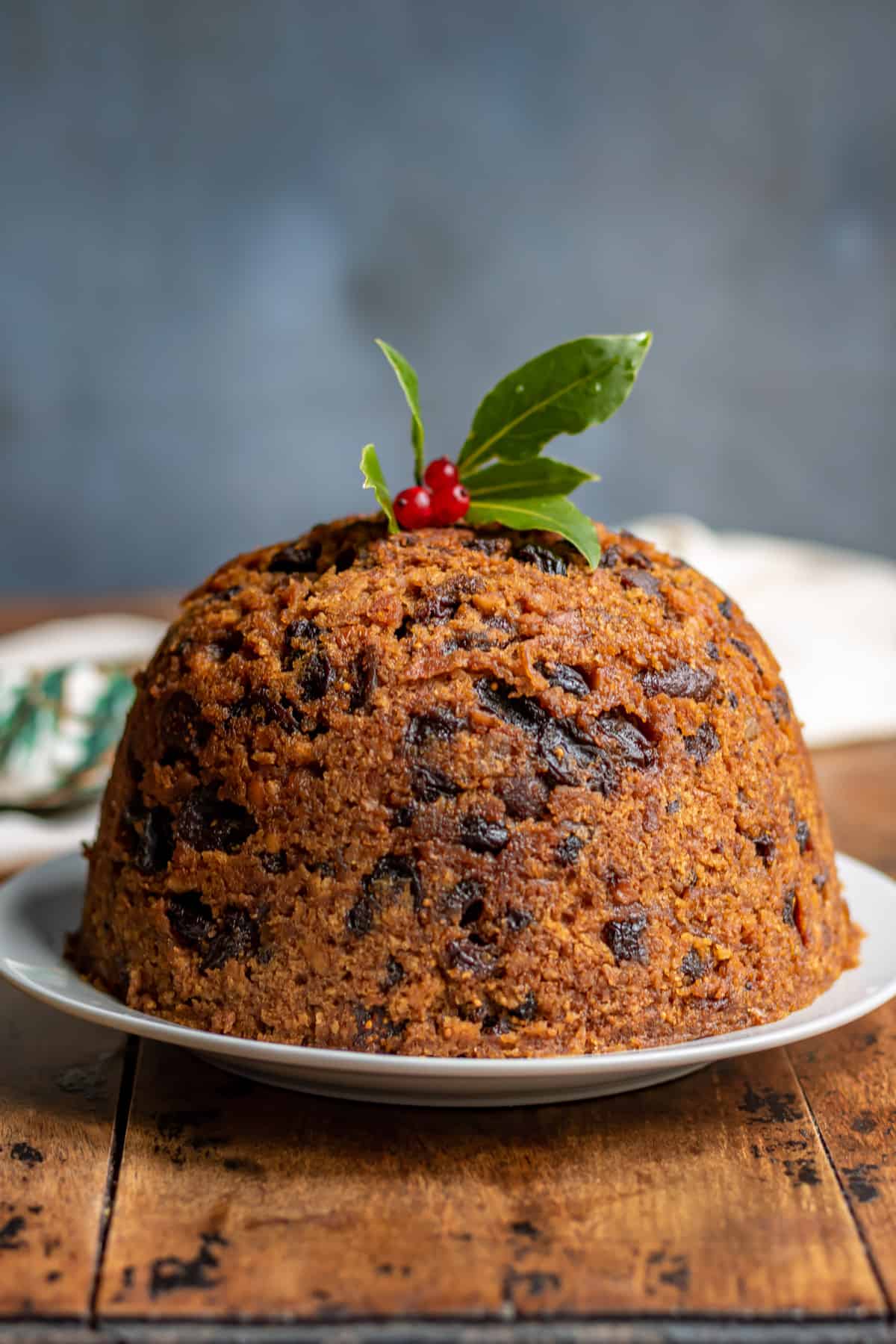 Table with a figgy pudding on a plate.
