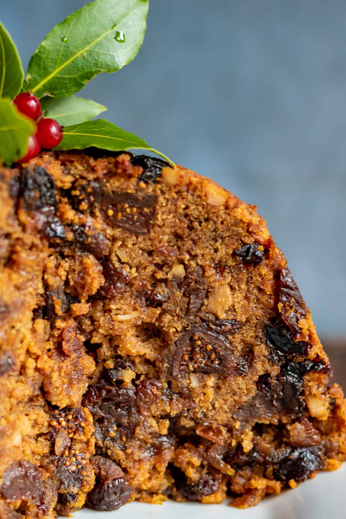 Close up of a figgy pudding with a slice taken out.