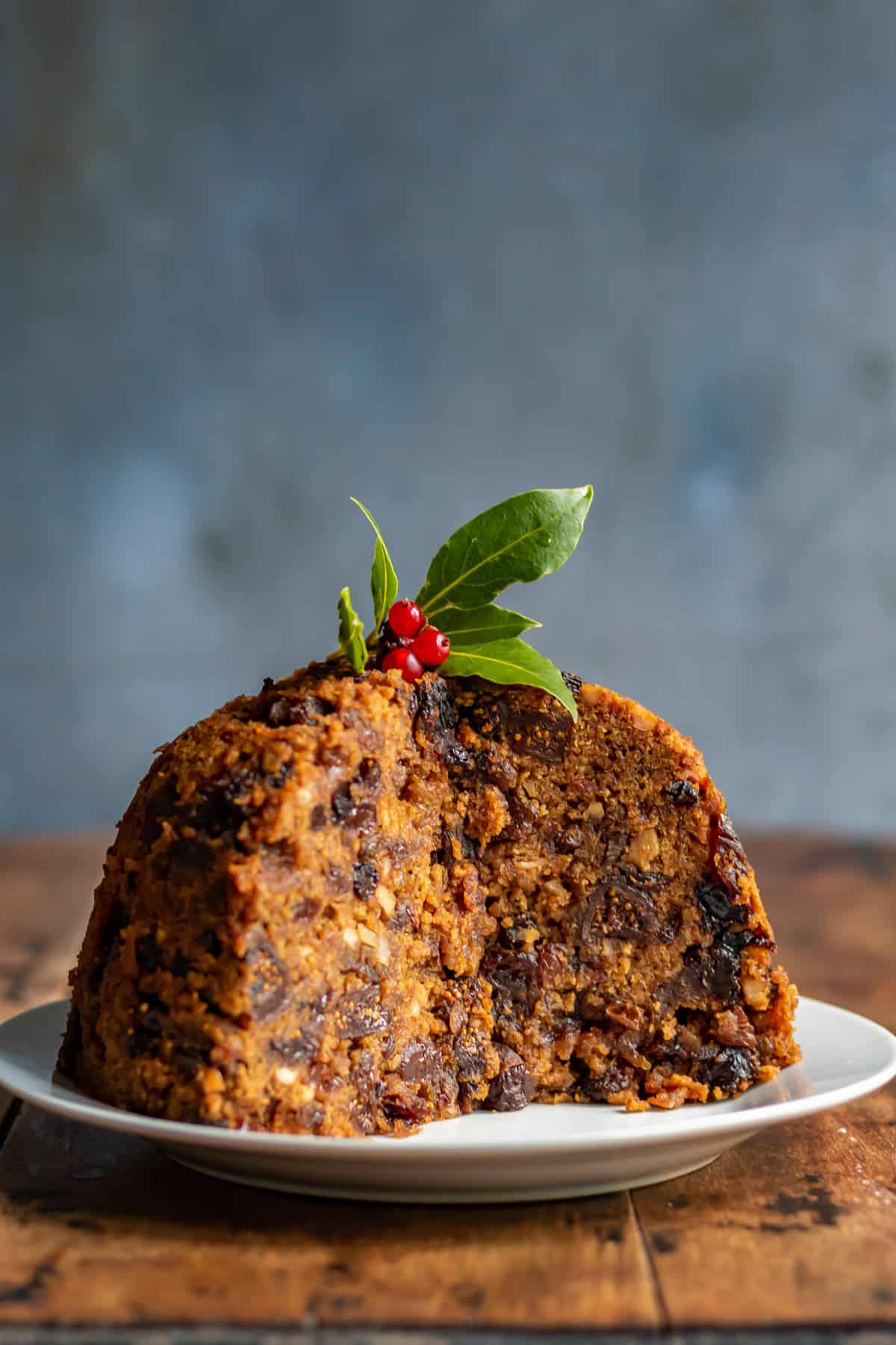 Figgy Pudding with a slice out on a table.