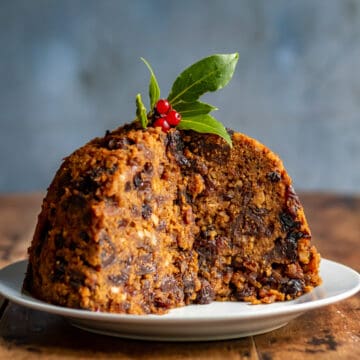 Figgy Pudding with a slice out on a table.