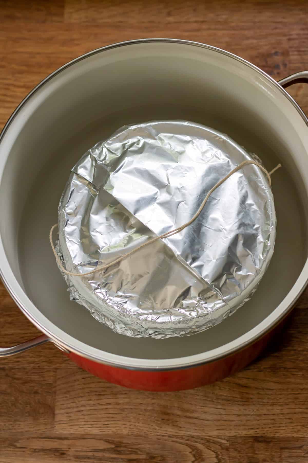 Pudding in a pot of water to steam.
