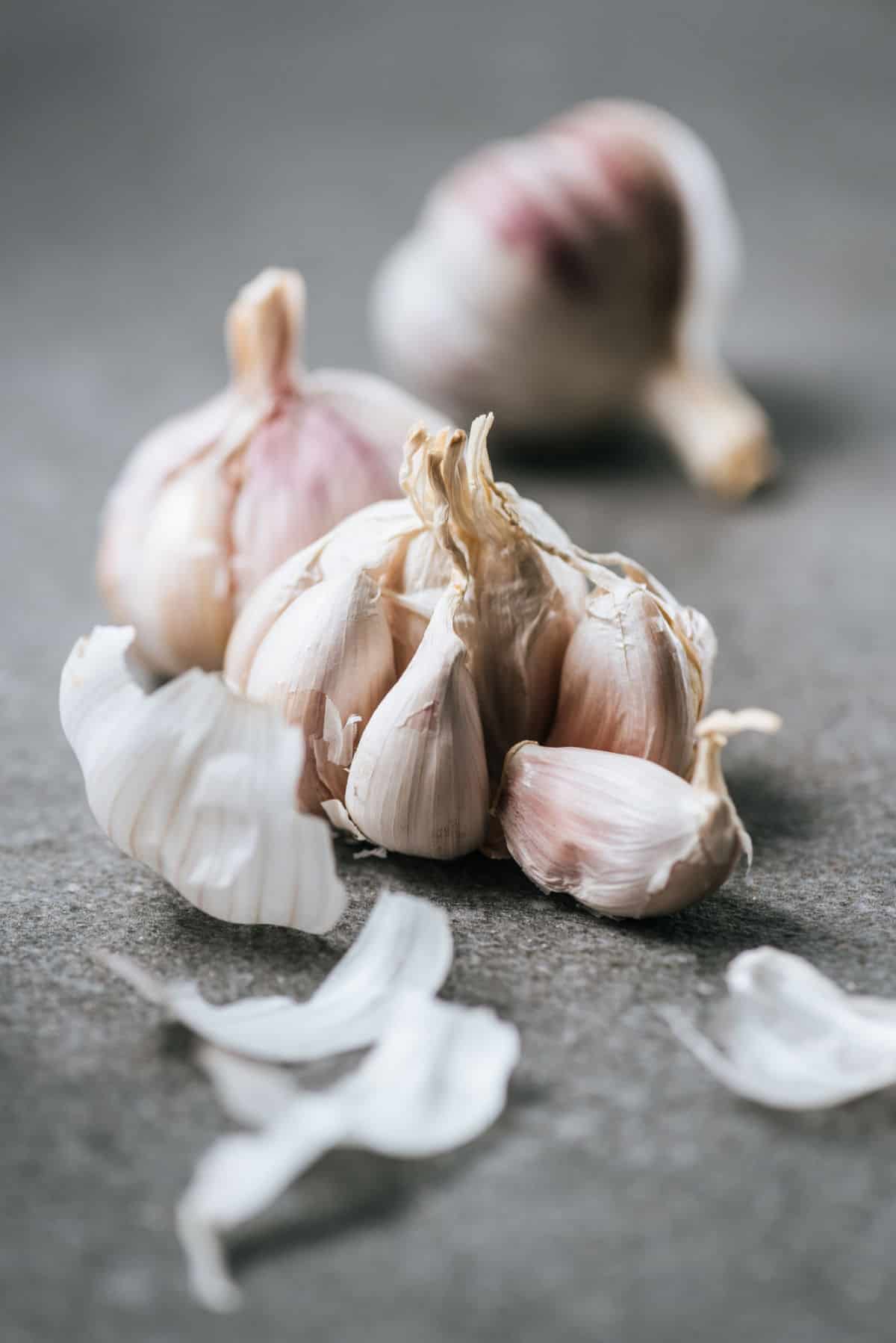 A bulb of garlic with some cloves pulled out.
