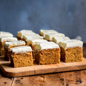 Squares of frosted pumpkin bars.