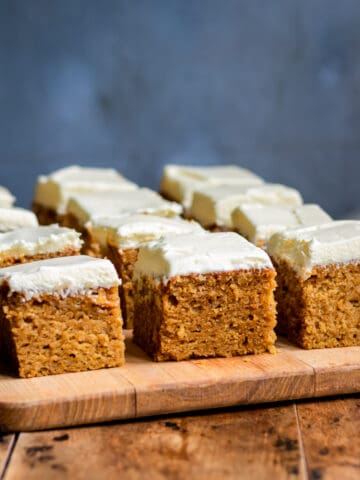 Squares of frosted pumpkin bars.
