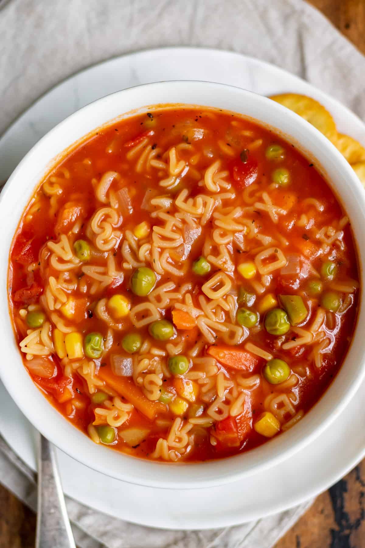 Close up of a bowl of alphabet soup.