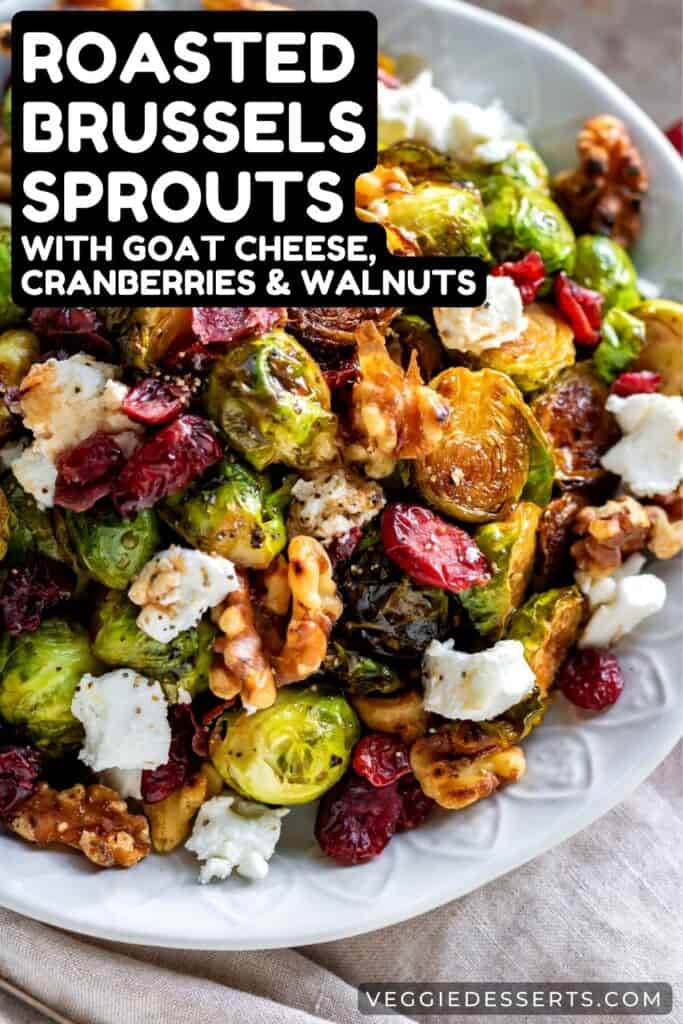 Plate of sprouts with text: Roasted Brussels Sprouts with Goat Cheese, Cranberries and Walnuts.