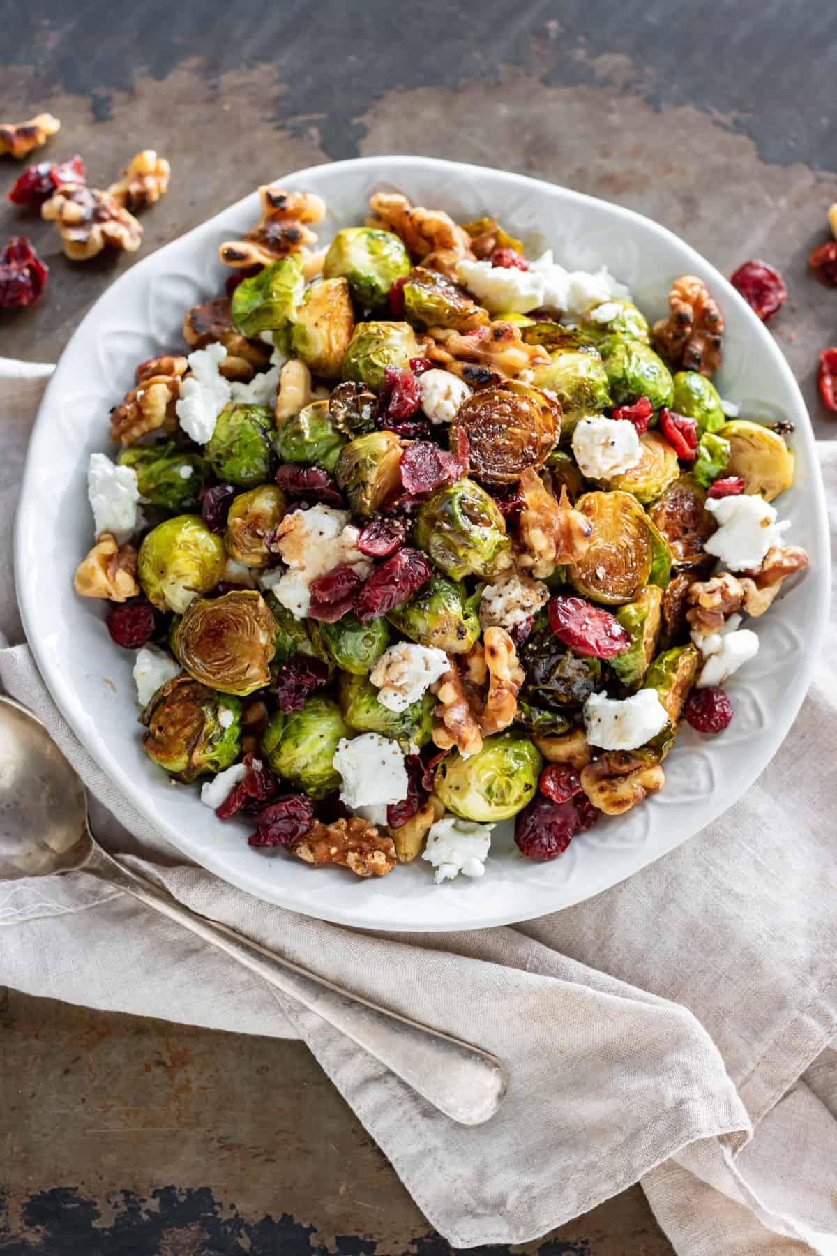 Table with a dish of roasted sprouts.