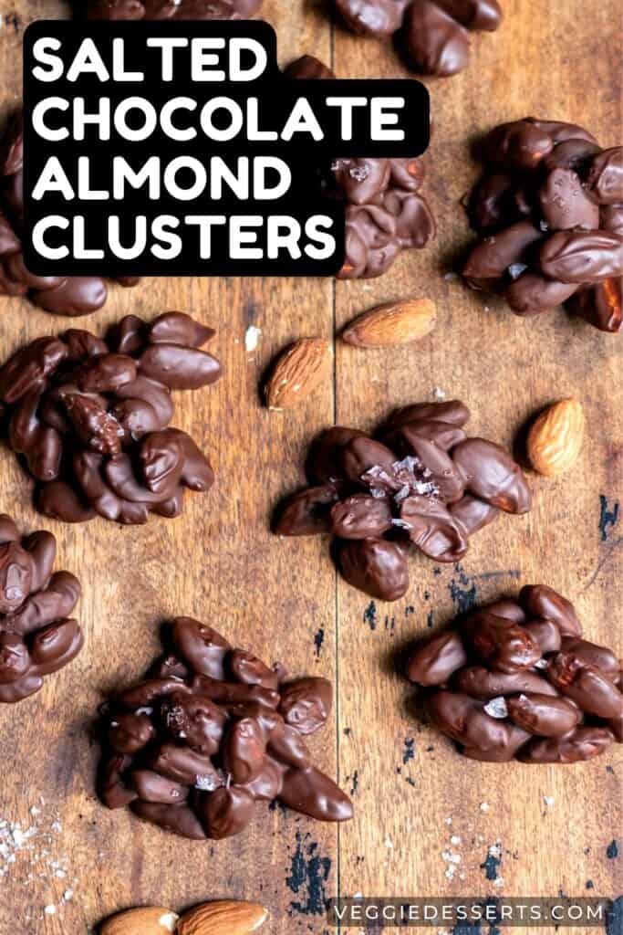 Chocolate almond clusters on a wooden board.
