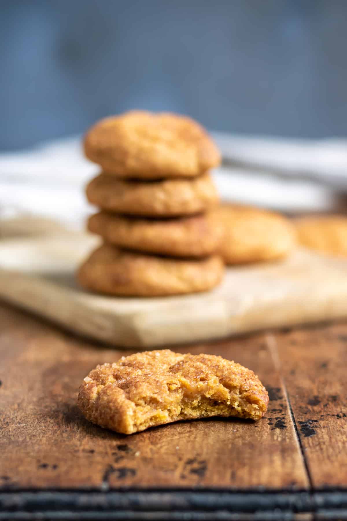 Pumpkin snickerdoodle cookie with a bite out.