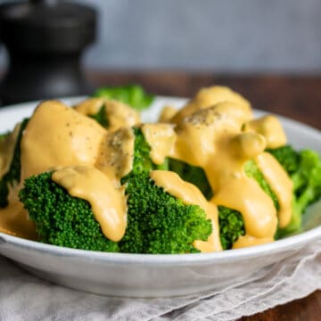 Close up of a plate of broccoli cheese.