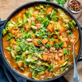 Table with a bowl of cannellini bean soup.