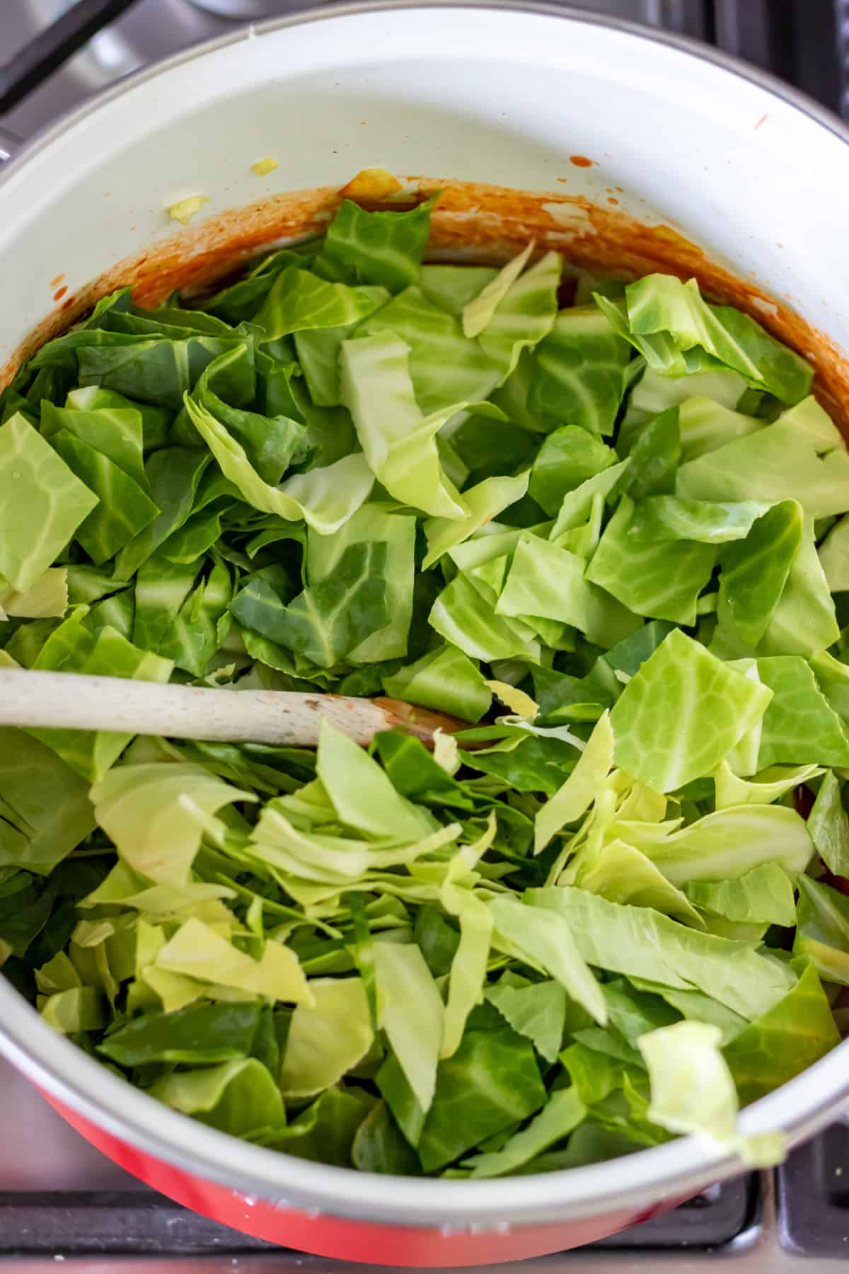 Adding chopped cabbage.