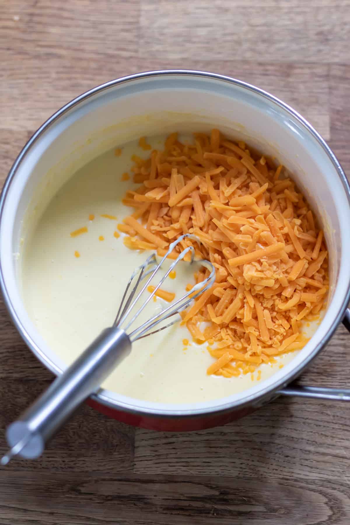 Shredded cheese added to the pot.