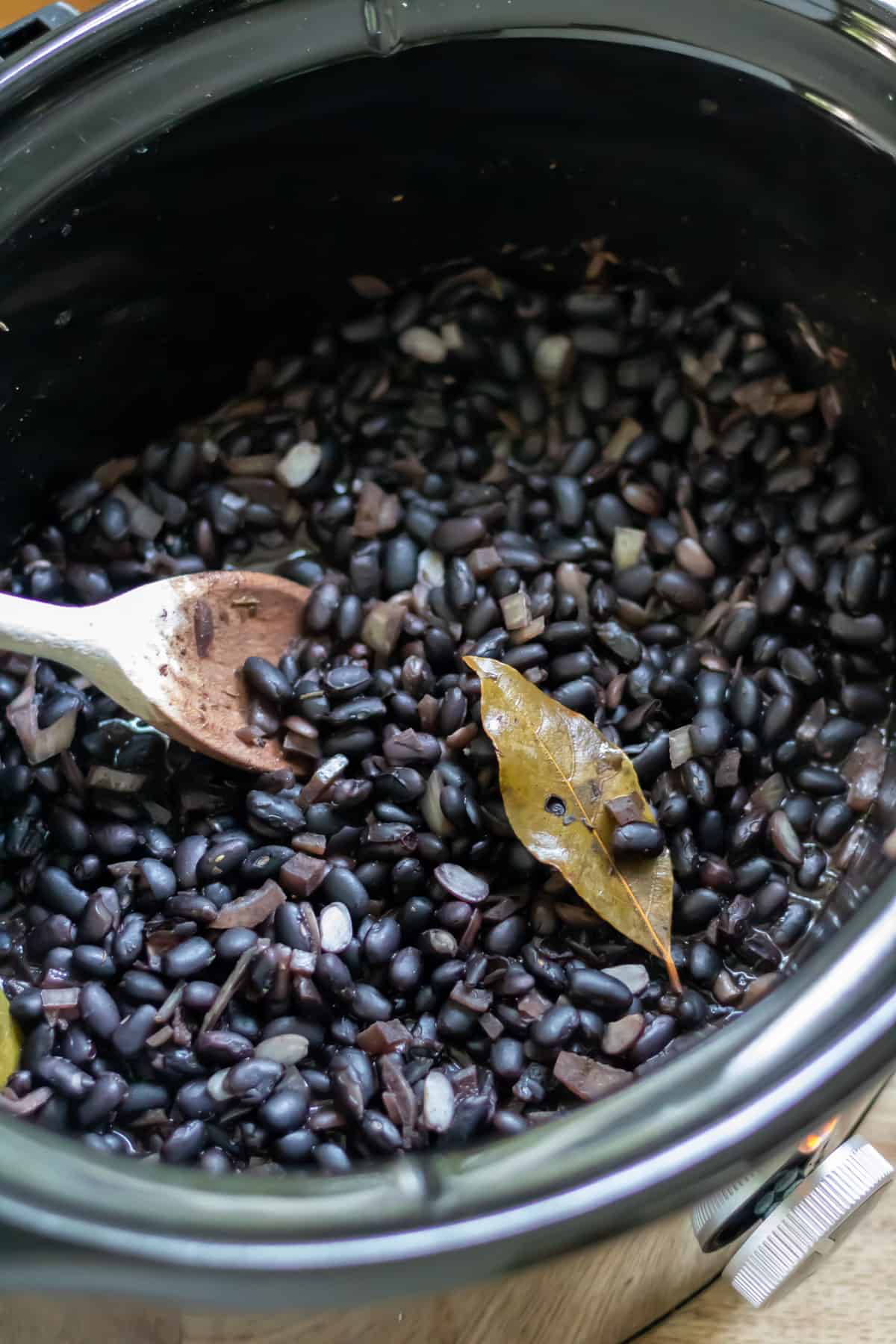 Black beans cooking in a slow cooker.
