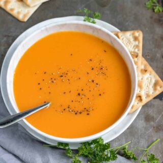 Bowl of carrot ginger soup on a table.