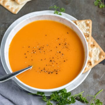 Bowl of carrot ginger soup on a table.