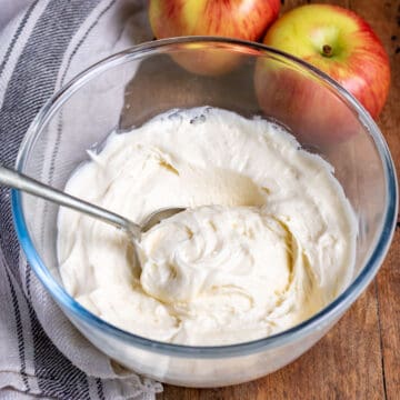 Bowl of apple frosting with a spoon in it.