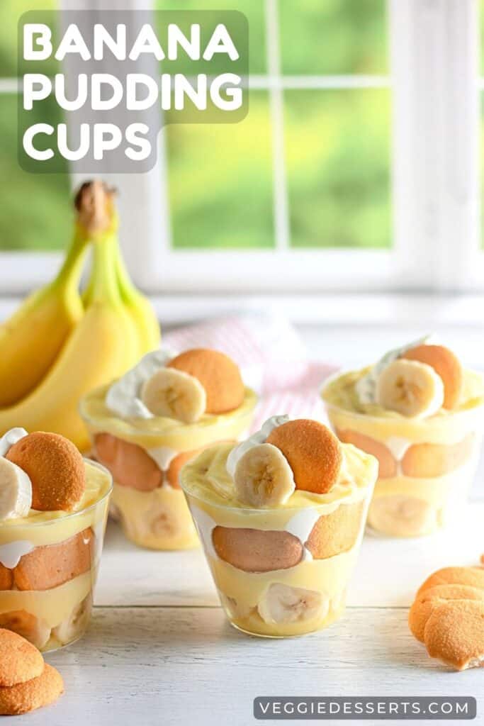 Table with cups of layered banana, pudding, nilla wafers, and whipped cream, with title: Banana Pudding Cups.