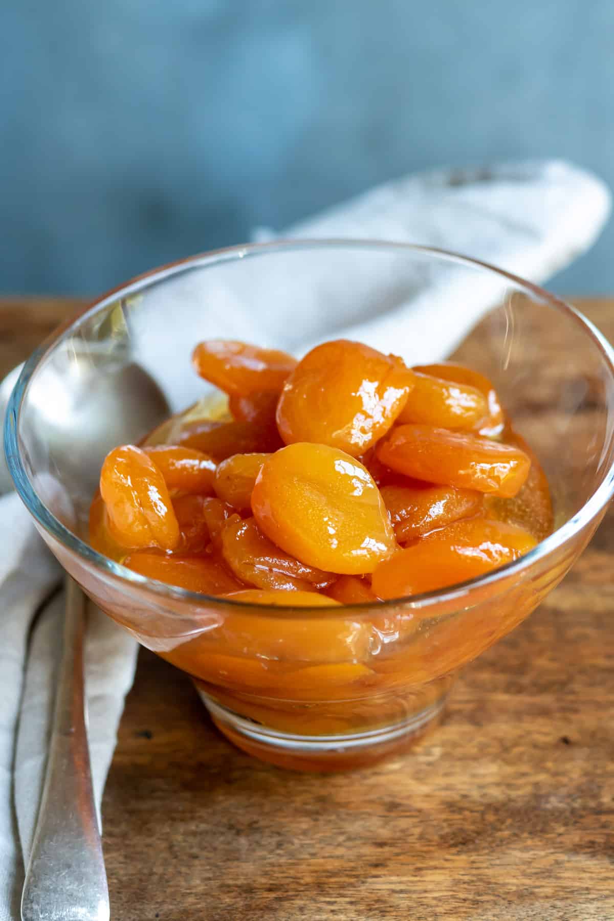 Table with a dish of glazed apricots.