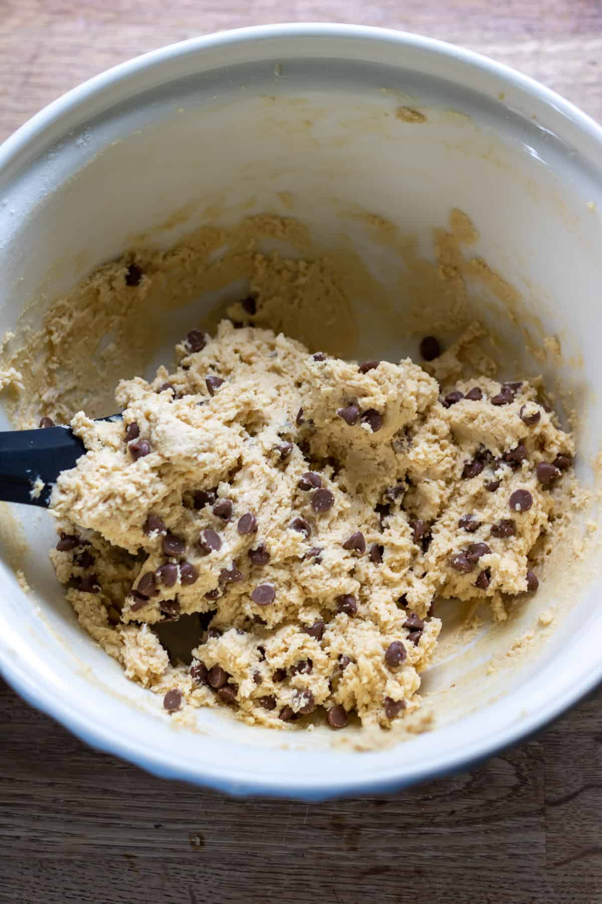 Folding chocolate chips into the cookie dough.