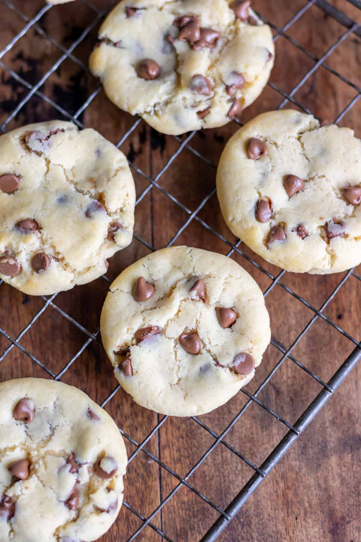 Chocolate chip condensed milk cookies cooling on a wire rack.