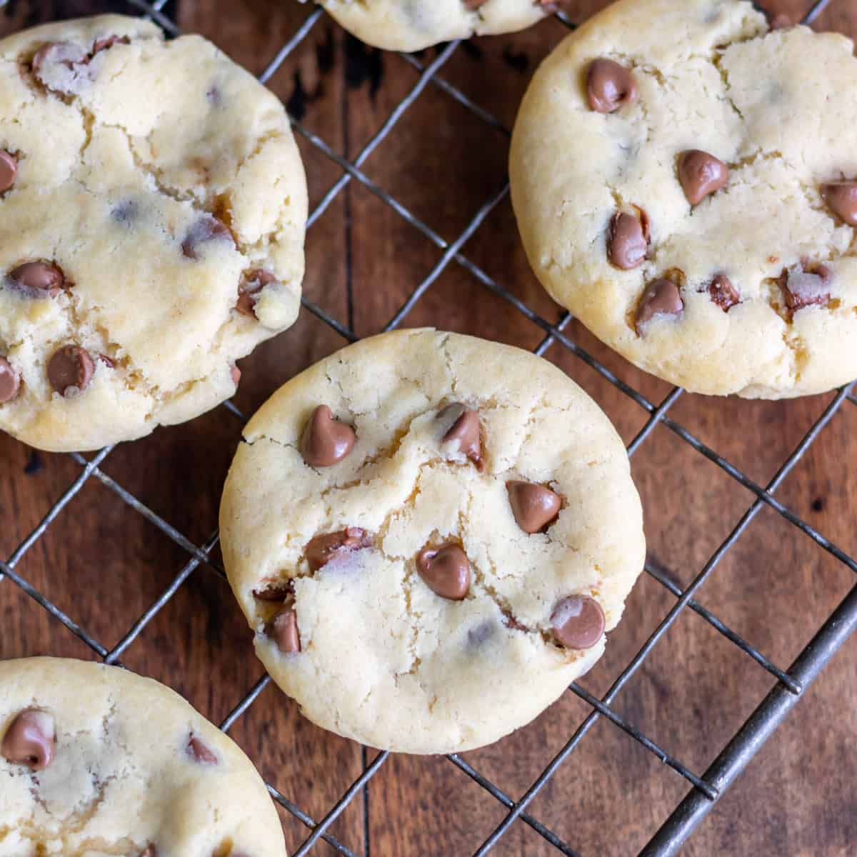 Chocolate chip condensed milk cookies cooling on a wire rack.