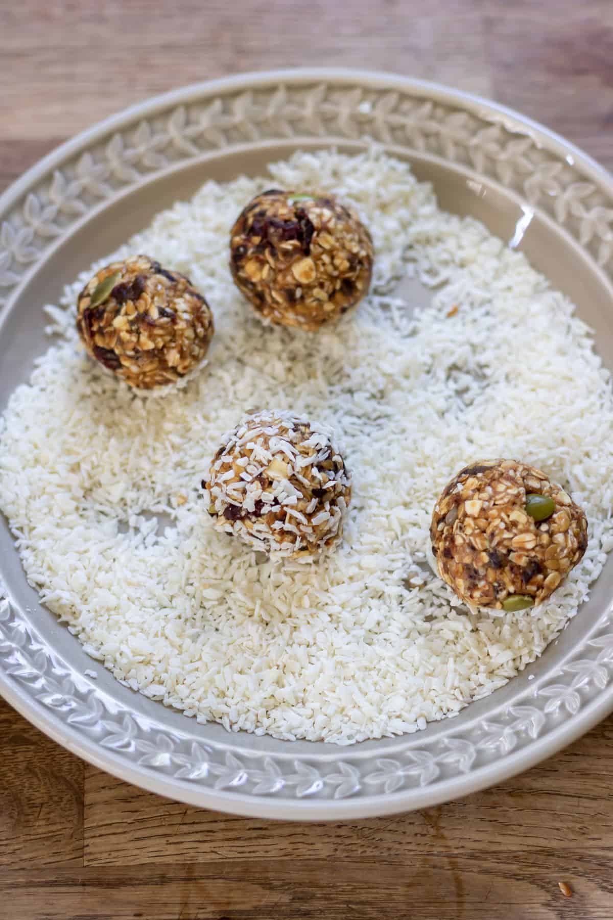 Rolling the dates protein balls in coconut.