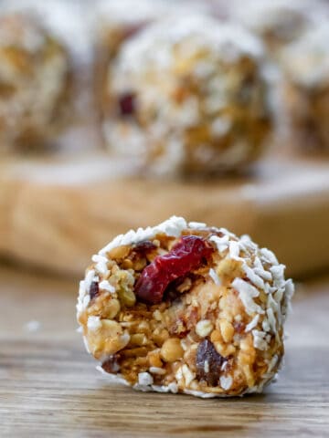 Date protein balls with one in front with a bite out.