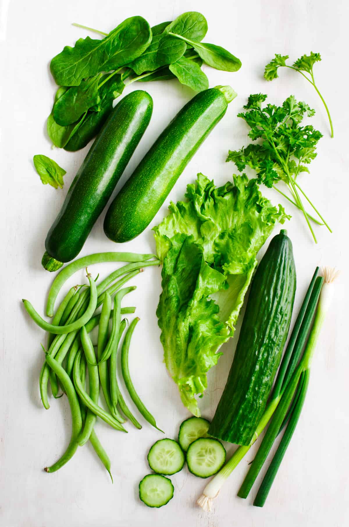 Various green vegetables on a table.