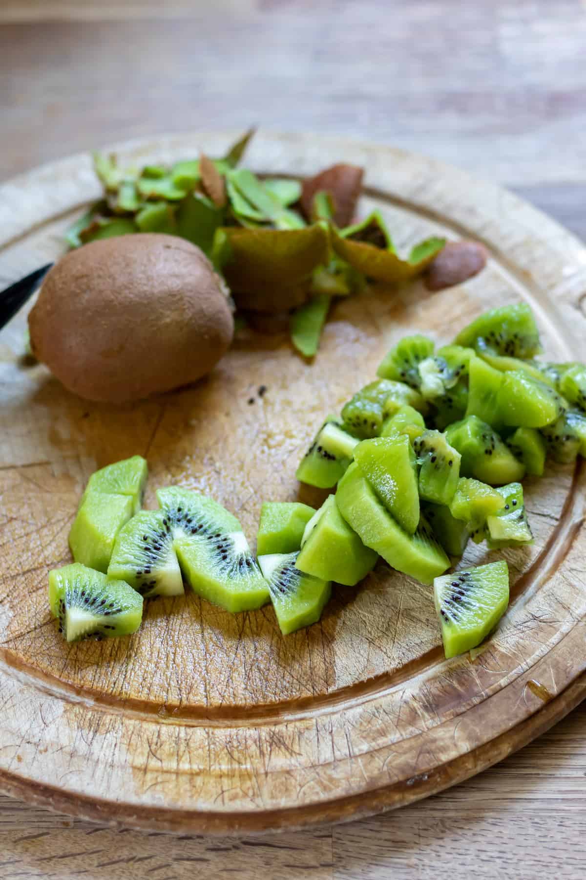 Peeling and chopping kiwi fruit.