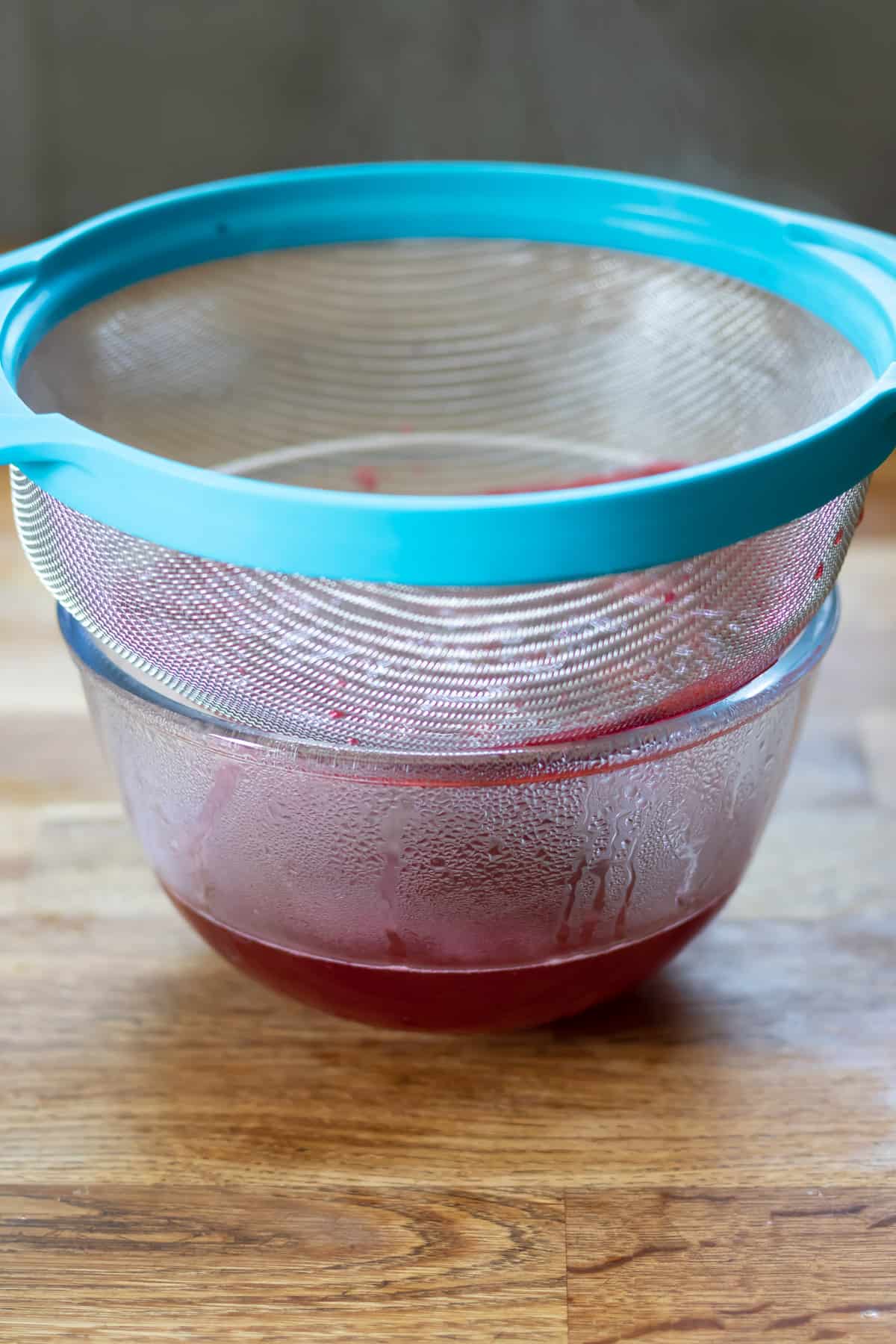 Bowl of syrup, with strainer on top.