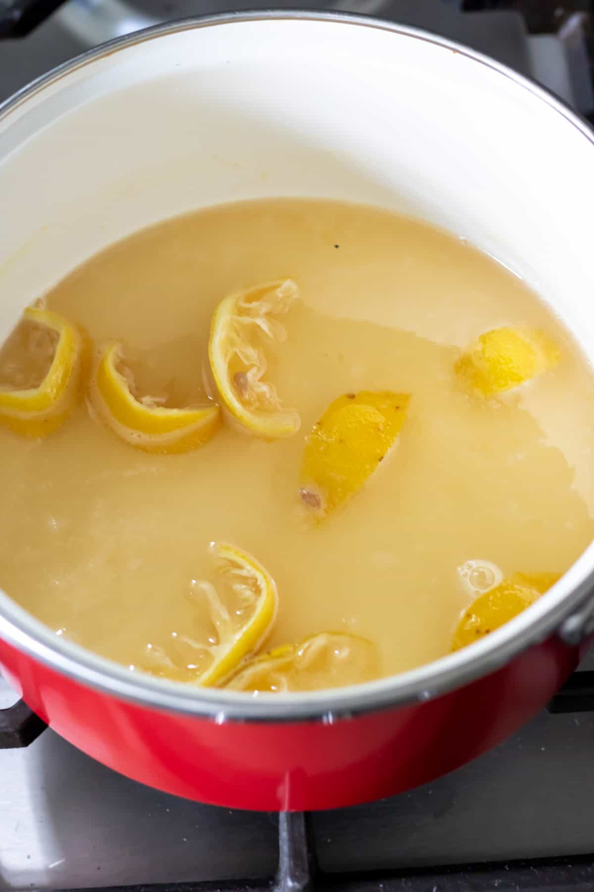 Sugar, lemon peels, lemon juice and water in a pot.