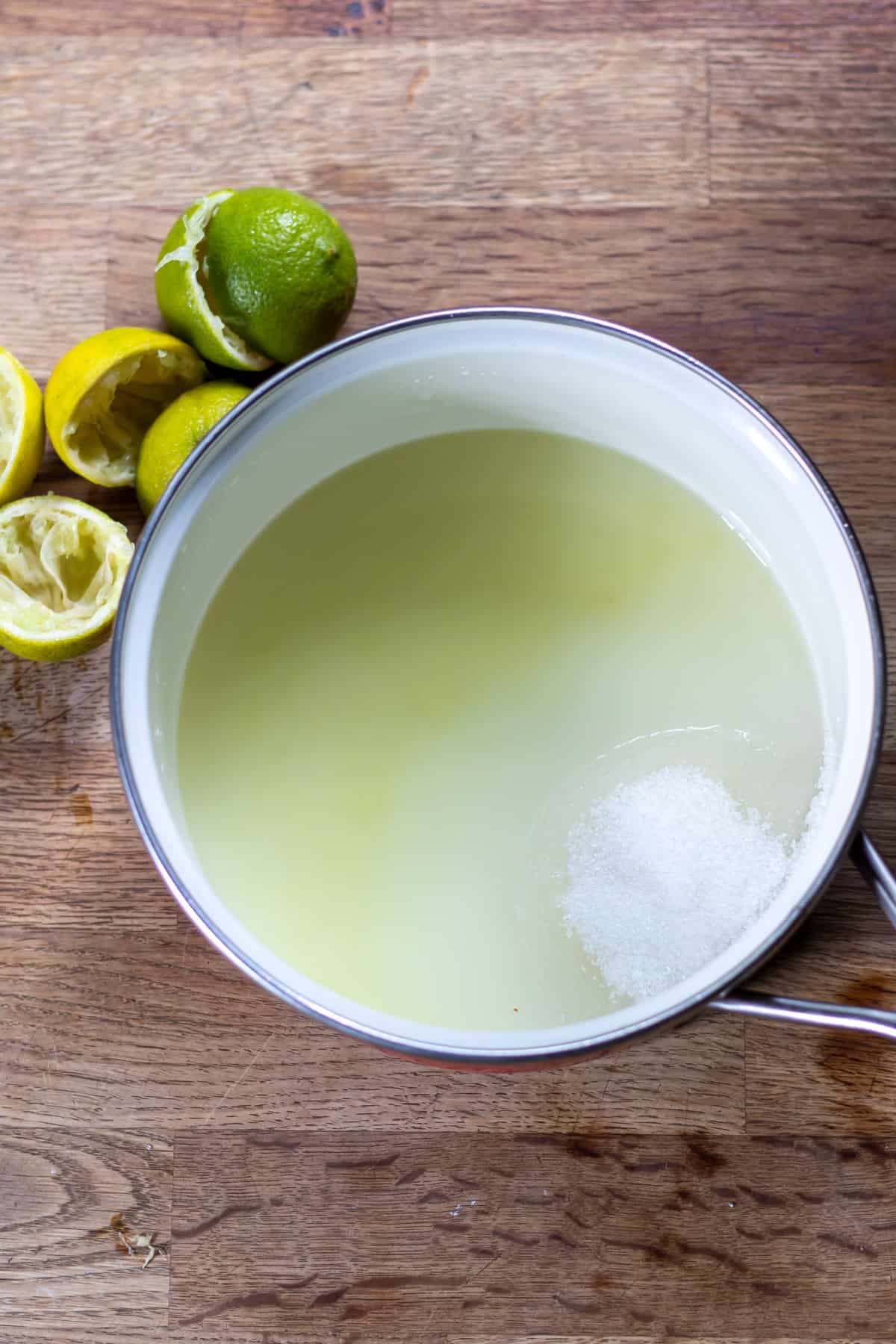Lime juice, water and sugar in a pot.