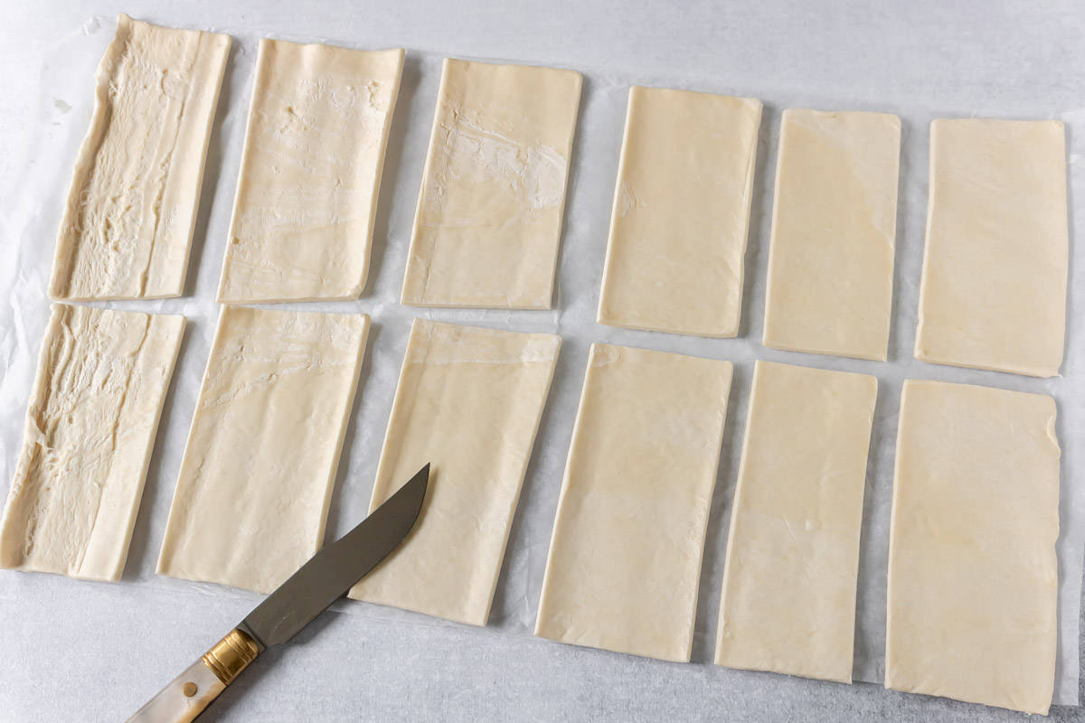 Cutting puff pastry into rectangles.