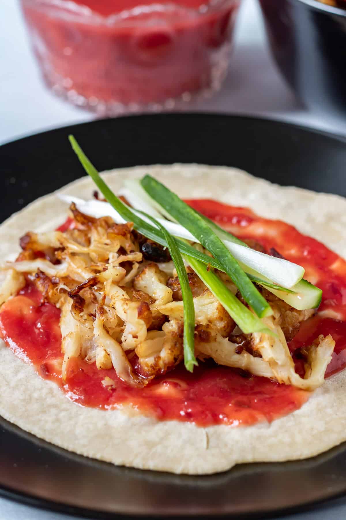 Homemade Chinese pancakes with homemade plum sauce, pulled cauliflower 'duck' and shredded spring onions.