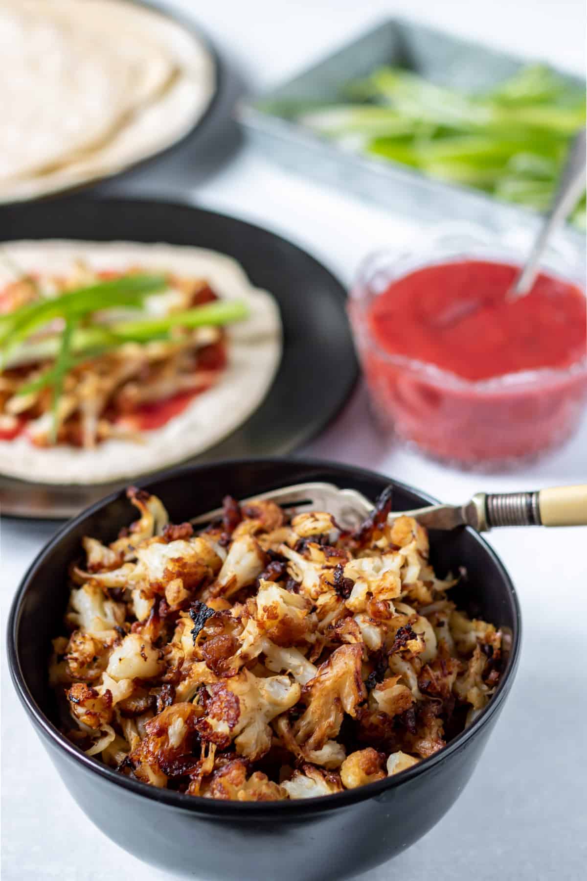 Bowl of roasted pulled cauliflower with Chinese seasonings to make vegan duck.