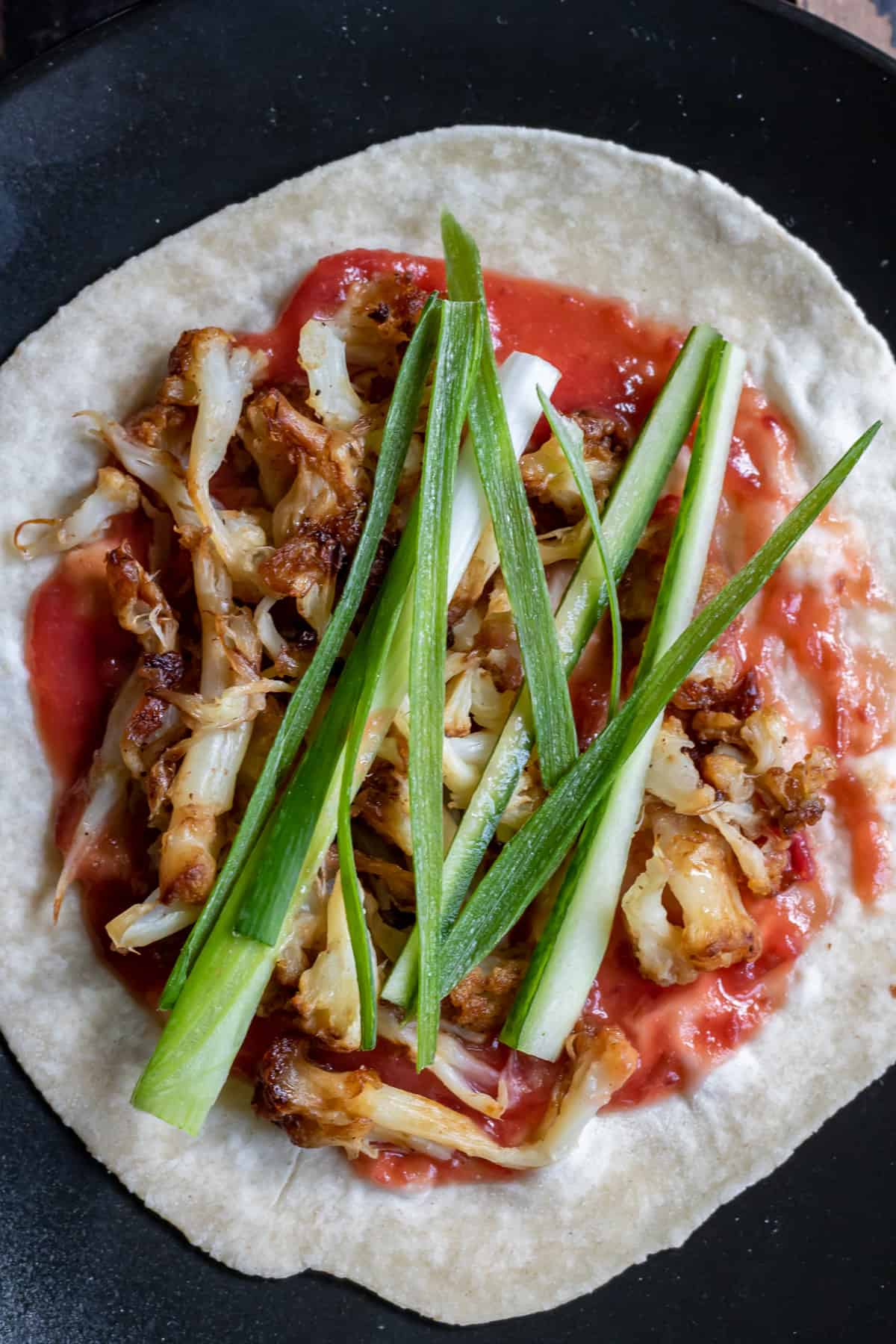 Homemade Chinese pancakes with homemade plum sauce, pulled cauliflower 'duck' and shredded spring onions.