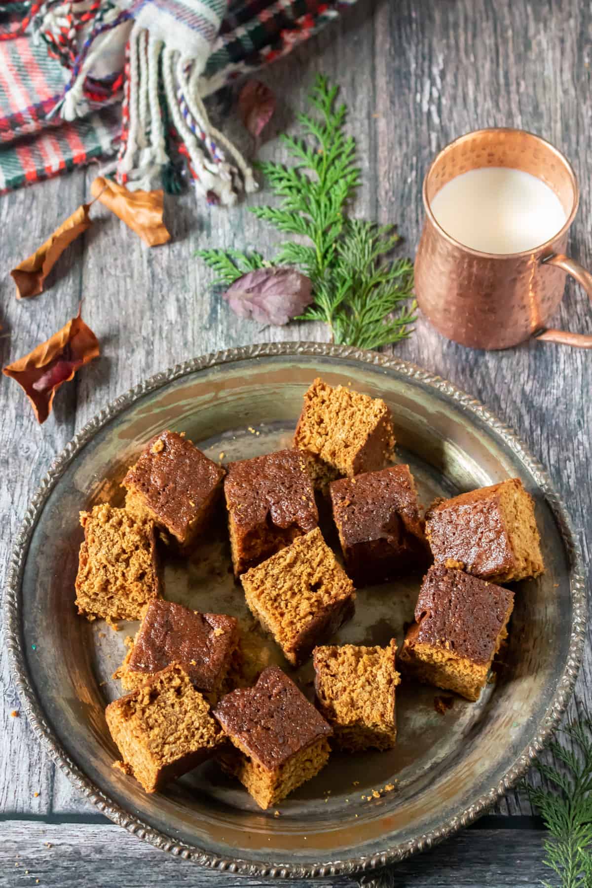 Looking down at a table with a platter of squares of Yorkshire parkin cake.