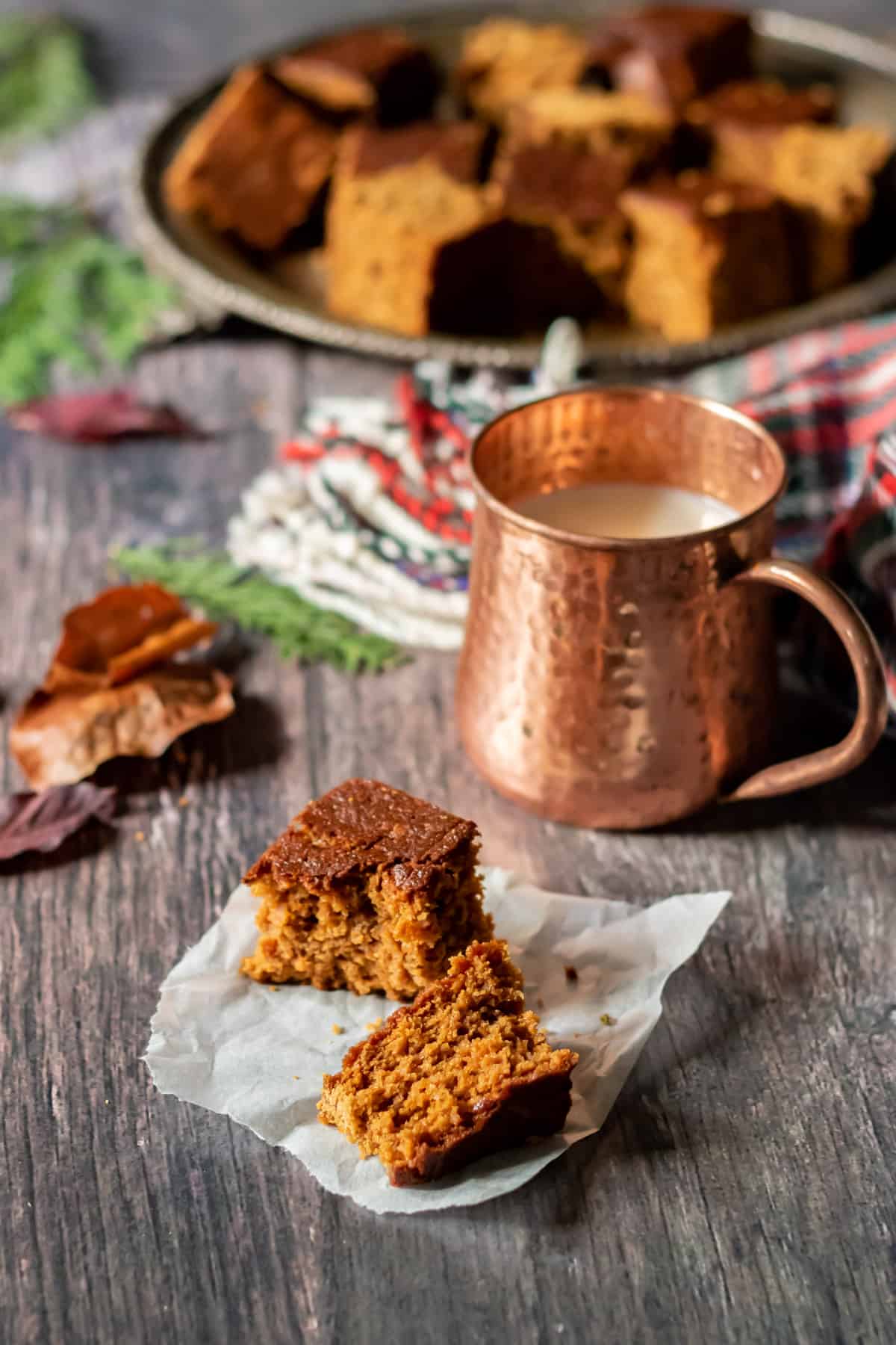 Wooden table with a mug and a piece of Yorkshire Parkin Cake.