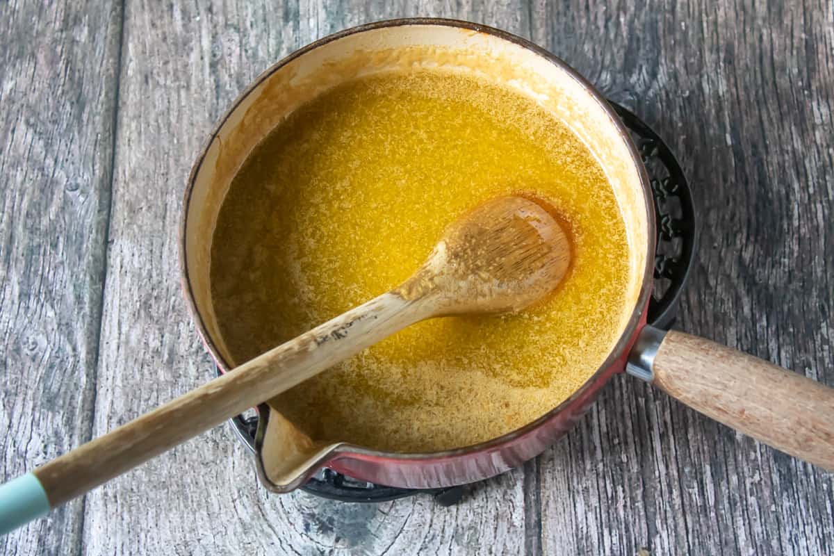 Melting the butter and sugar in a pan.