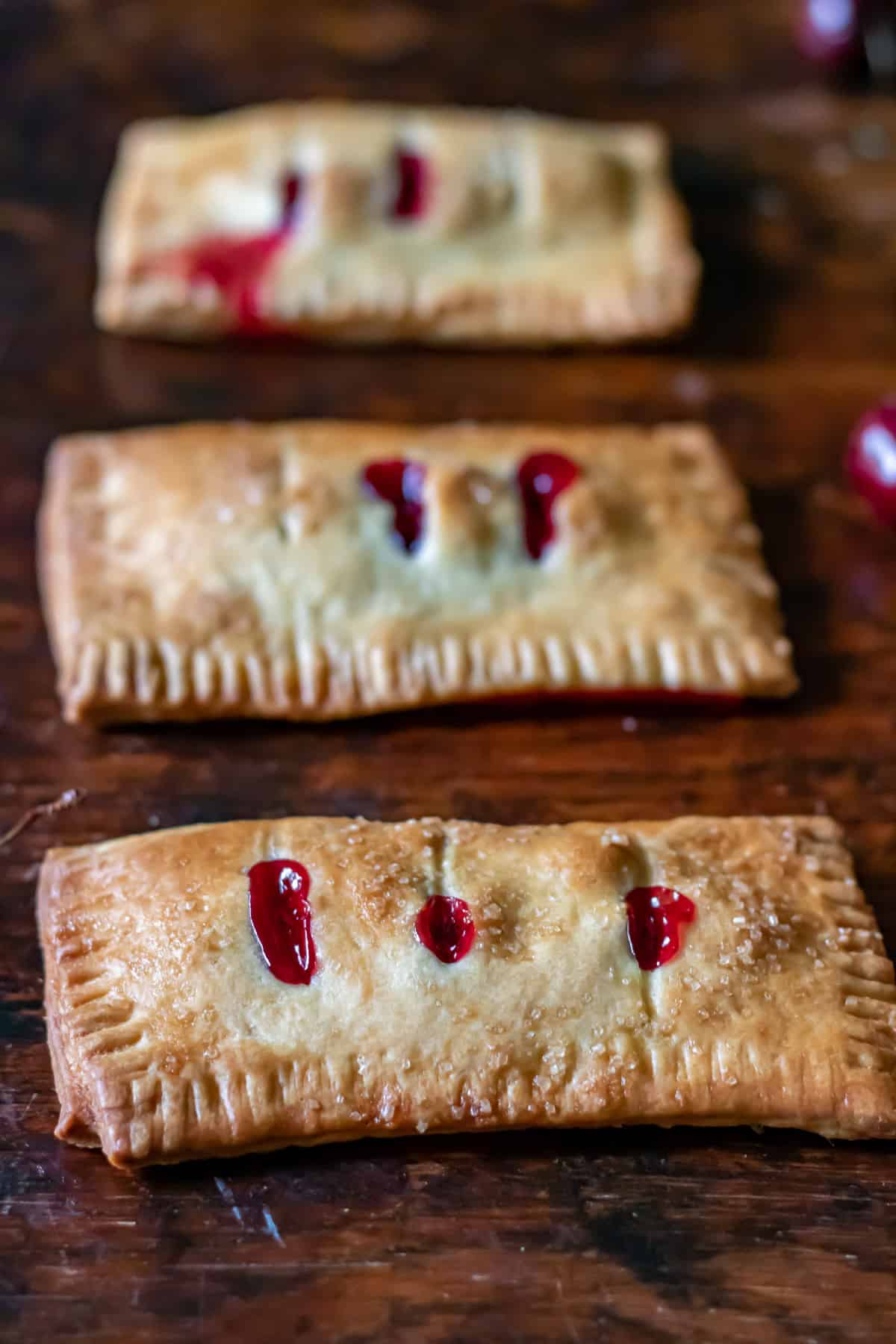 Table with a row of cherry hand pies.