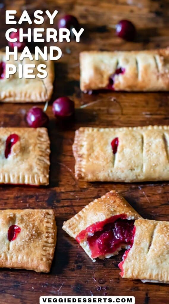 Rows of cherry pies on a wooden table, with text: Easy Cherry Hand Pies.