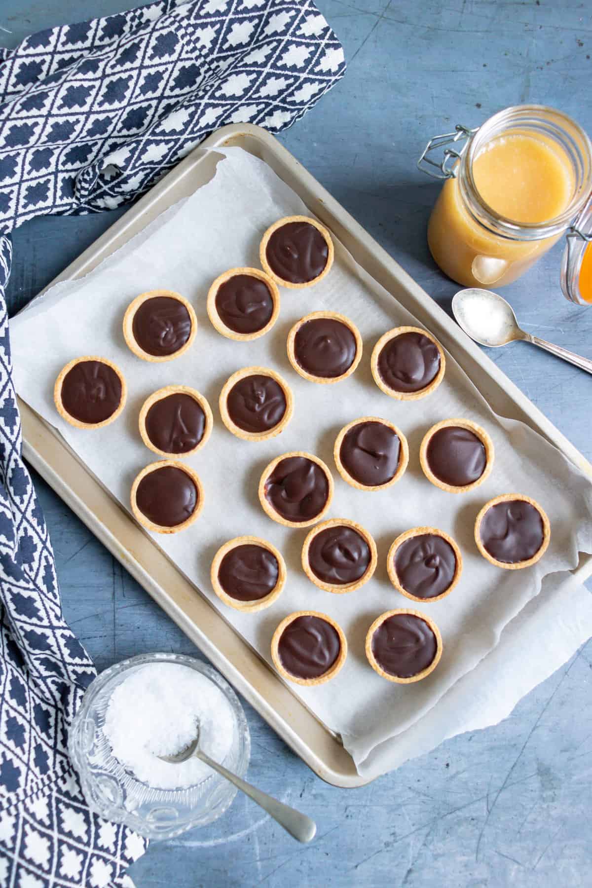Chocolate ganache spooned into pastry shells and chilled.