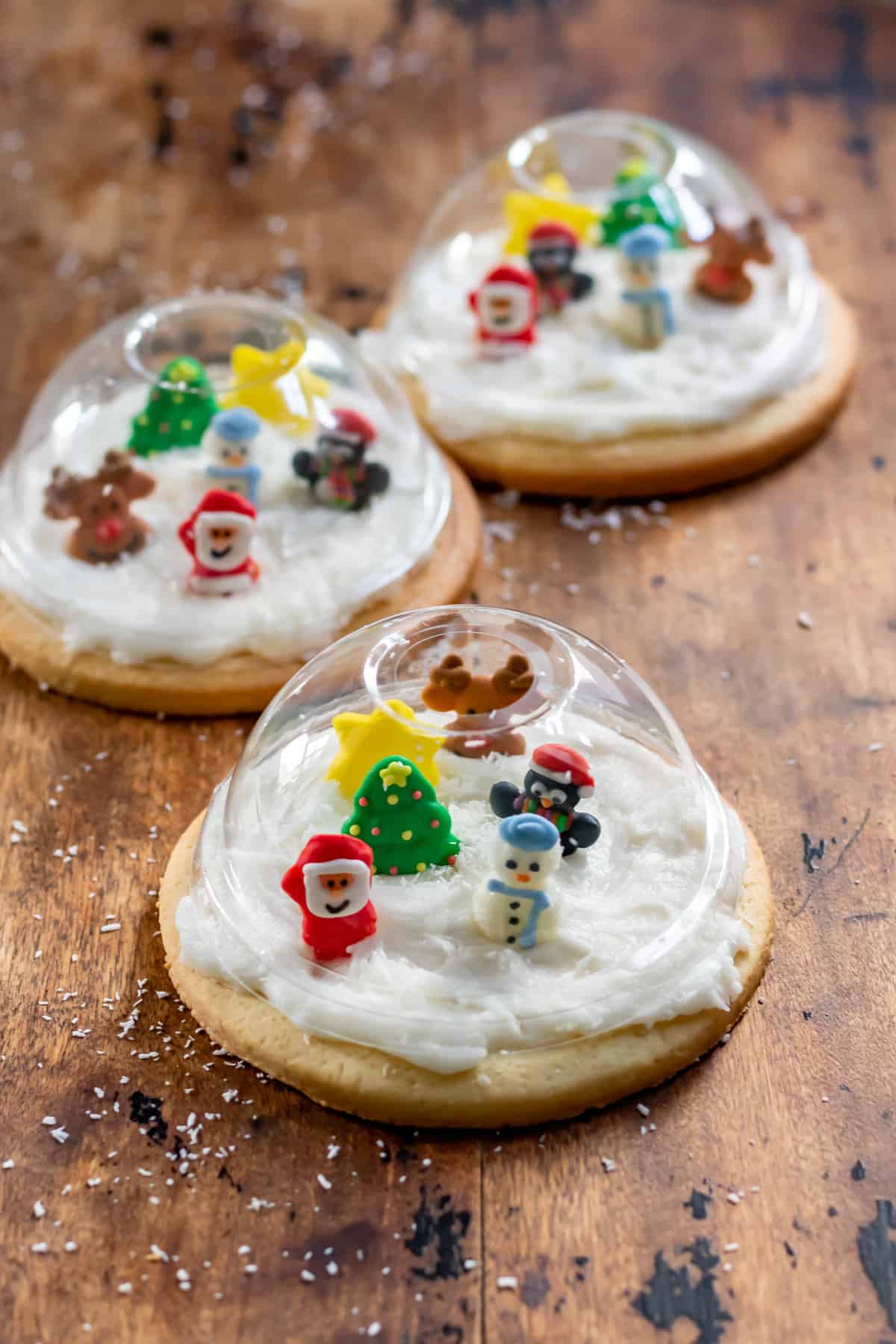 A table with three Snow Globe Cookies.