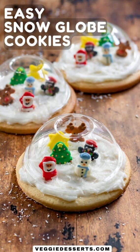 Table with cookies, and text: Easy Snow Globe Cookies.