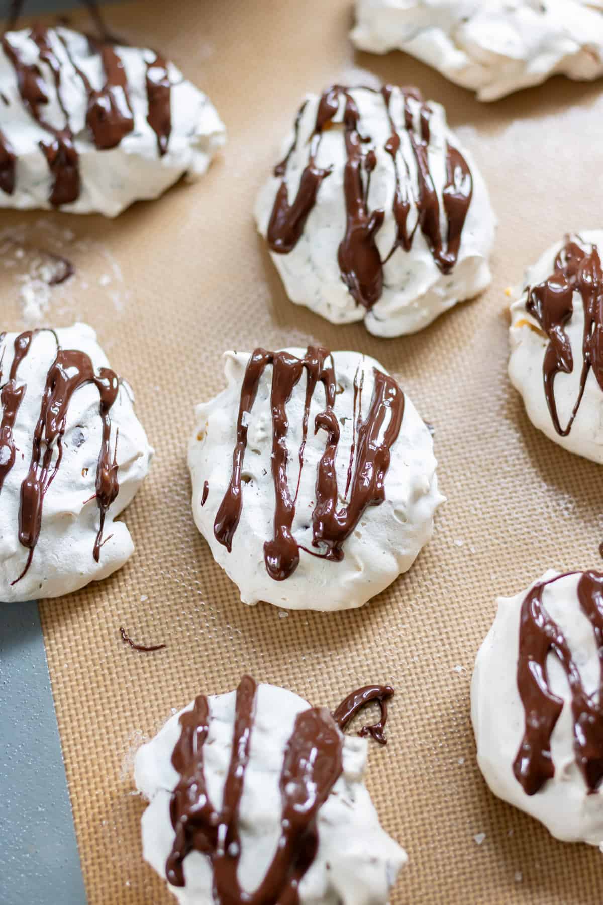 Melted chocolate drizzled onto the cornflake meringue cookies, then sprinkled with sea salt.