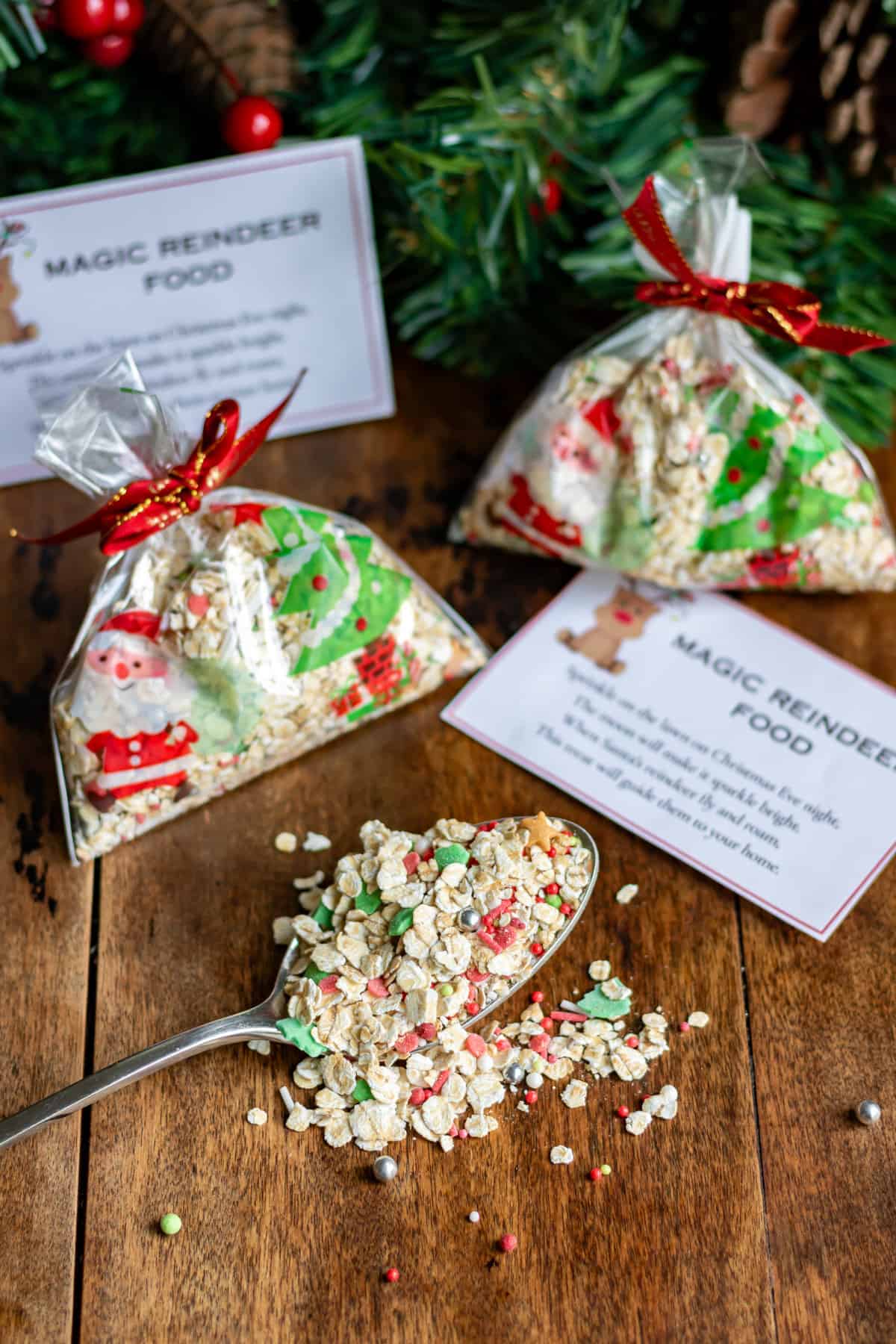 Spoonful of reindeer food in front of cellophane bags of it, and printable tags.