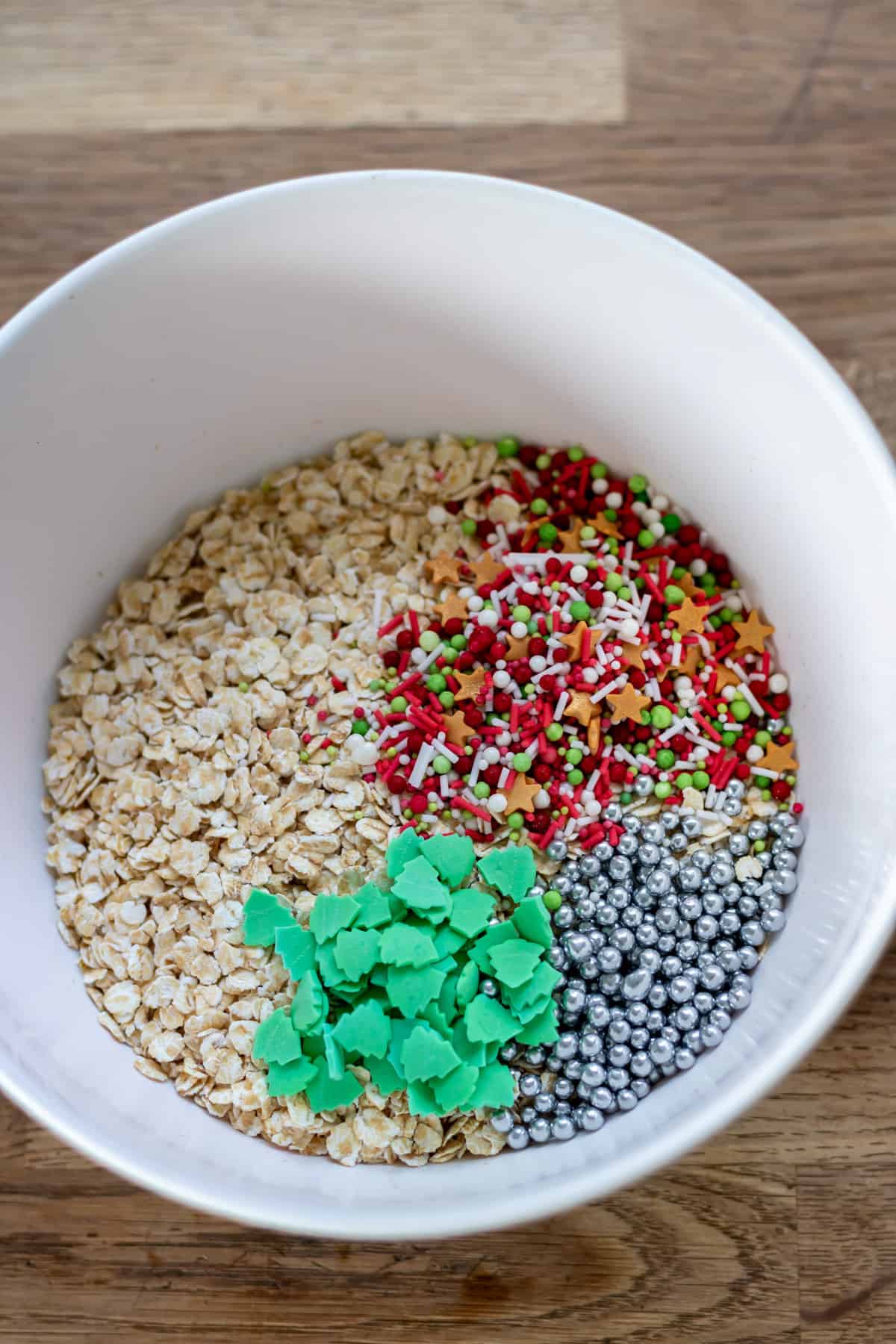 Ingredients for magical reindeer food in a bowl - oats and sprinkles.