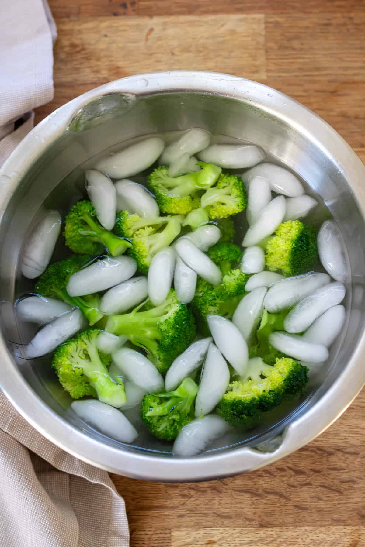 Blanched broccoli in an ice bath.