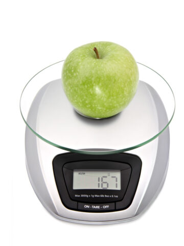An apple on a digital kitchen scale to show how to tare a scale.